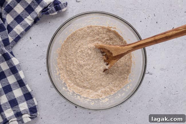 Blueberry Oat Bran Muffins — Flourless, Sugar-Free Recipe 5 Stirring muffin batter with a wooden spoon.