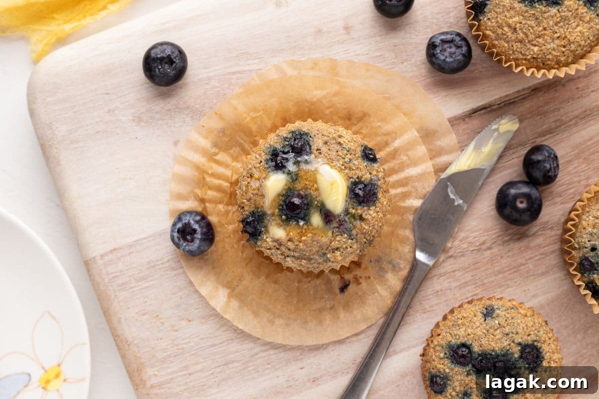 Blueberry Oat Bran Muffins — Flourless, Sugar-Free Recipe 7 Top of blueberry muffin with butter.