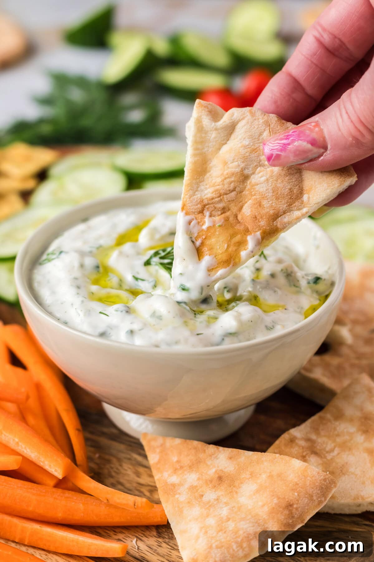 Authentic Greek Tzatziki Sauce Recipe — Creamy Cucumber Yogurt Dip 3 Pita bread being dipped in Tzatziki Sauce