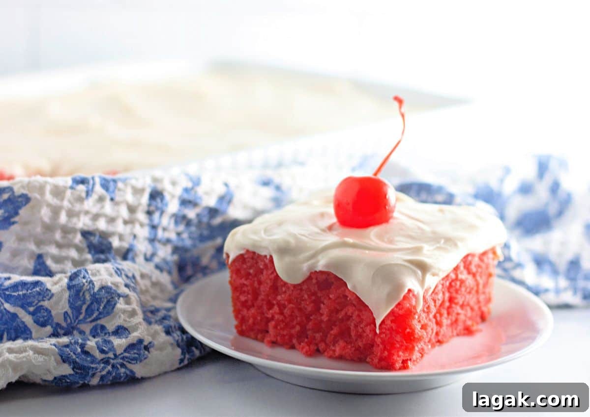 Moist Maraschino Cherry Cake Recipe with Cherry Glaze 11 Slice of maraschino cherry cake on a plate.