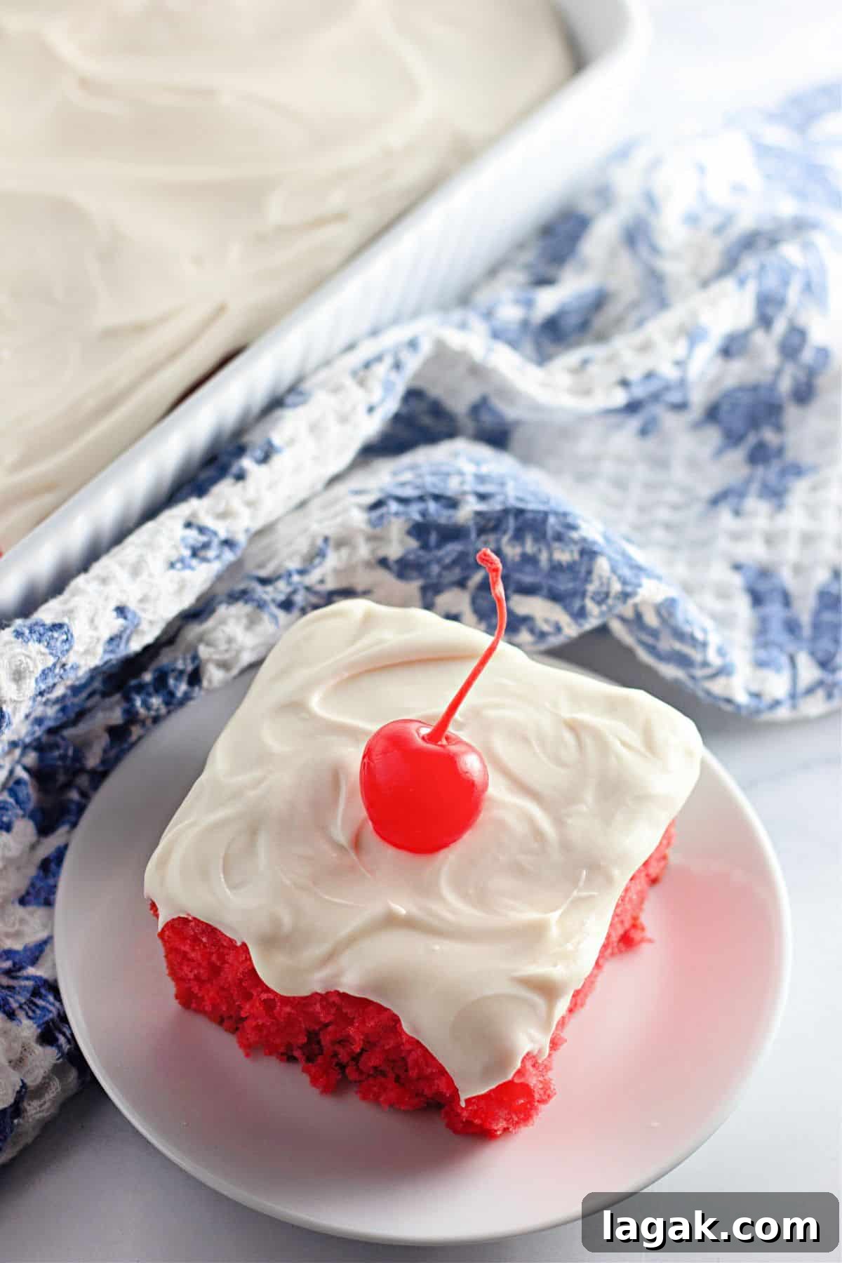 Moist Maraschino Cherry Cake Recipe with Cherry Glaze 3 Slice of maraschino cherry cake on a plate.