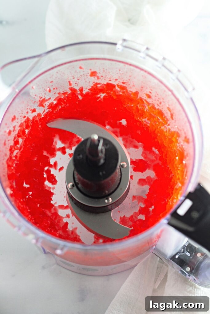 Moist Maraschino Cherry Cake Recipe with Cherry Glaze 5 Cherries being chopped in a food processor.