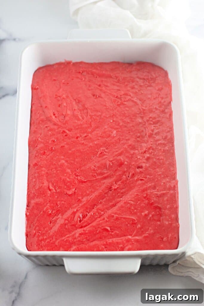 Moist Maraschino Cherry Cake Recipe with Cherry Glaze 8 Batter in a white baking dish.