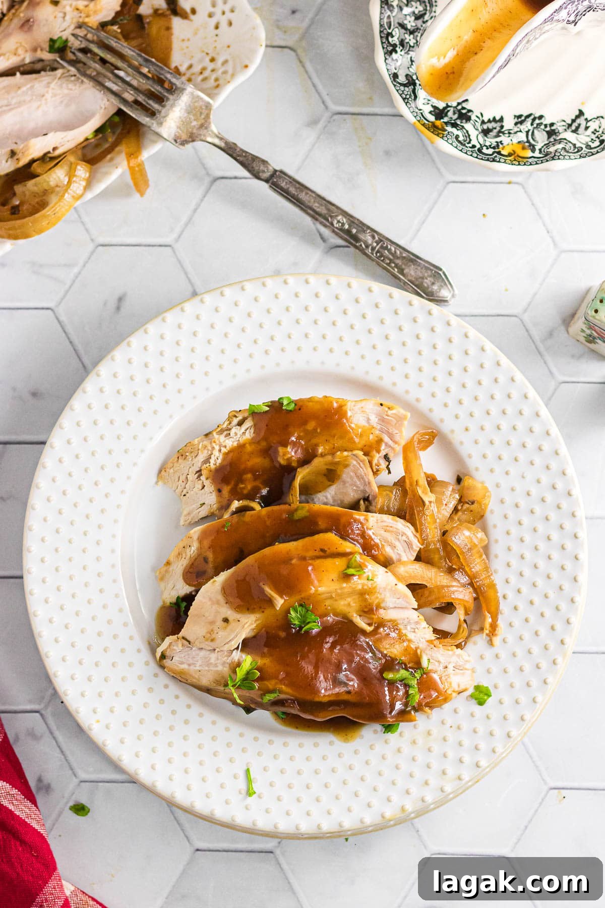 Chipotle Citrus Turkey Breast Slow Cooker Recipe 2 Sliced chipotle citrus turkey with onions on a dinner plate.