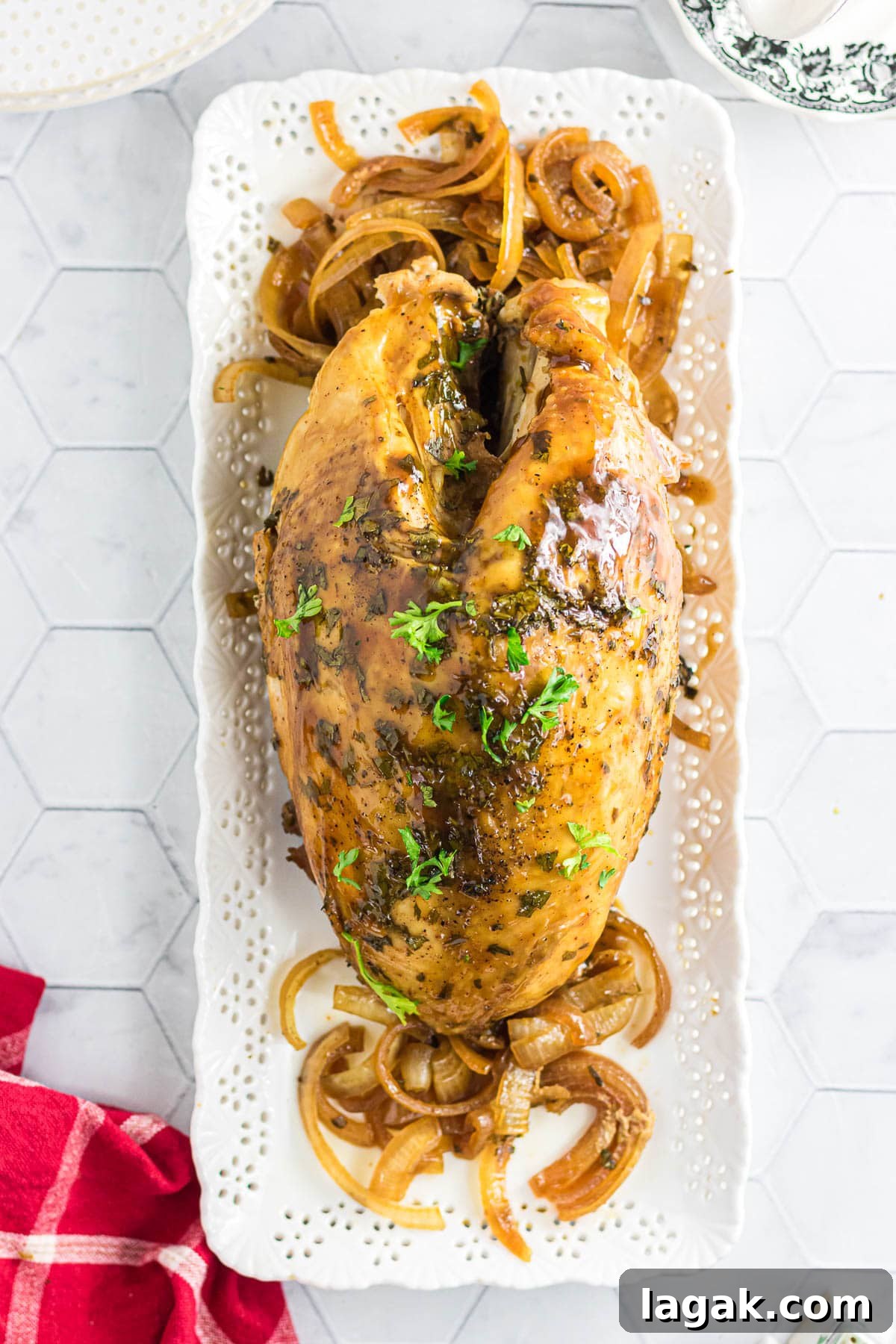 Chipotle Citrus Turkey Breast Slow Cooker Recipe 7 The chipotle citrus turkey breast on a serving platter with onions and cilantro.