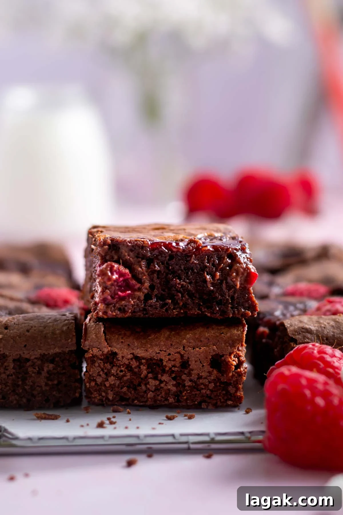 stack of two brownies with milk in the background