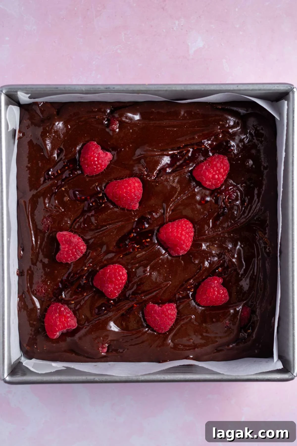 raspberry jam and fresh raspberries swirled on brownie batter
