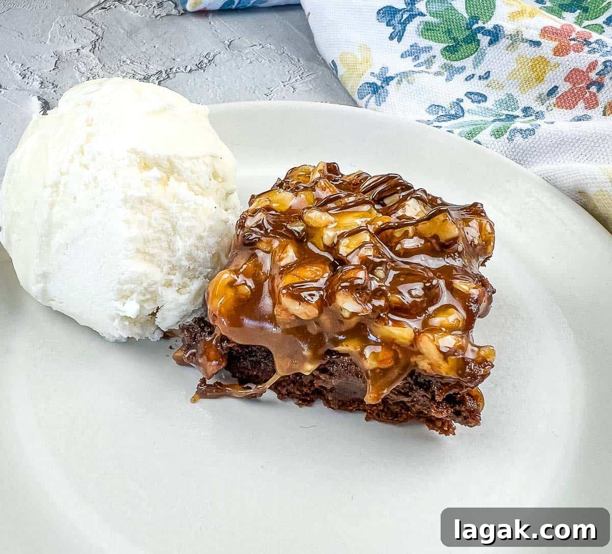 27 Cozy Fall Desserts That Taste Like Brown Sugar, Butter, and Memories 25 A piece of Turtle Brownie with ice cream on a plate.