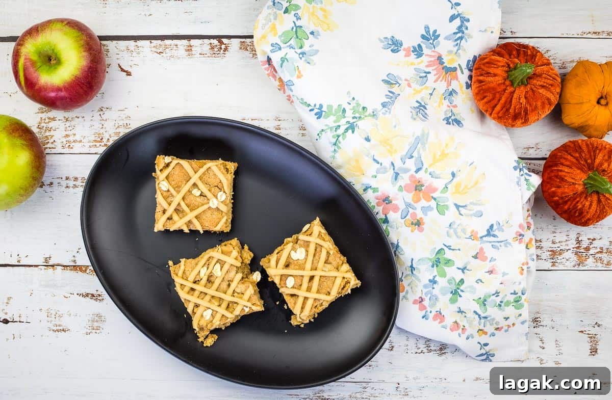 27 Cozy Fall Desserts That Taste Like Brown Sugar, Butter, and Memories 27 Two brown butter apple blondies were placed on a white surface.