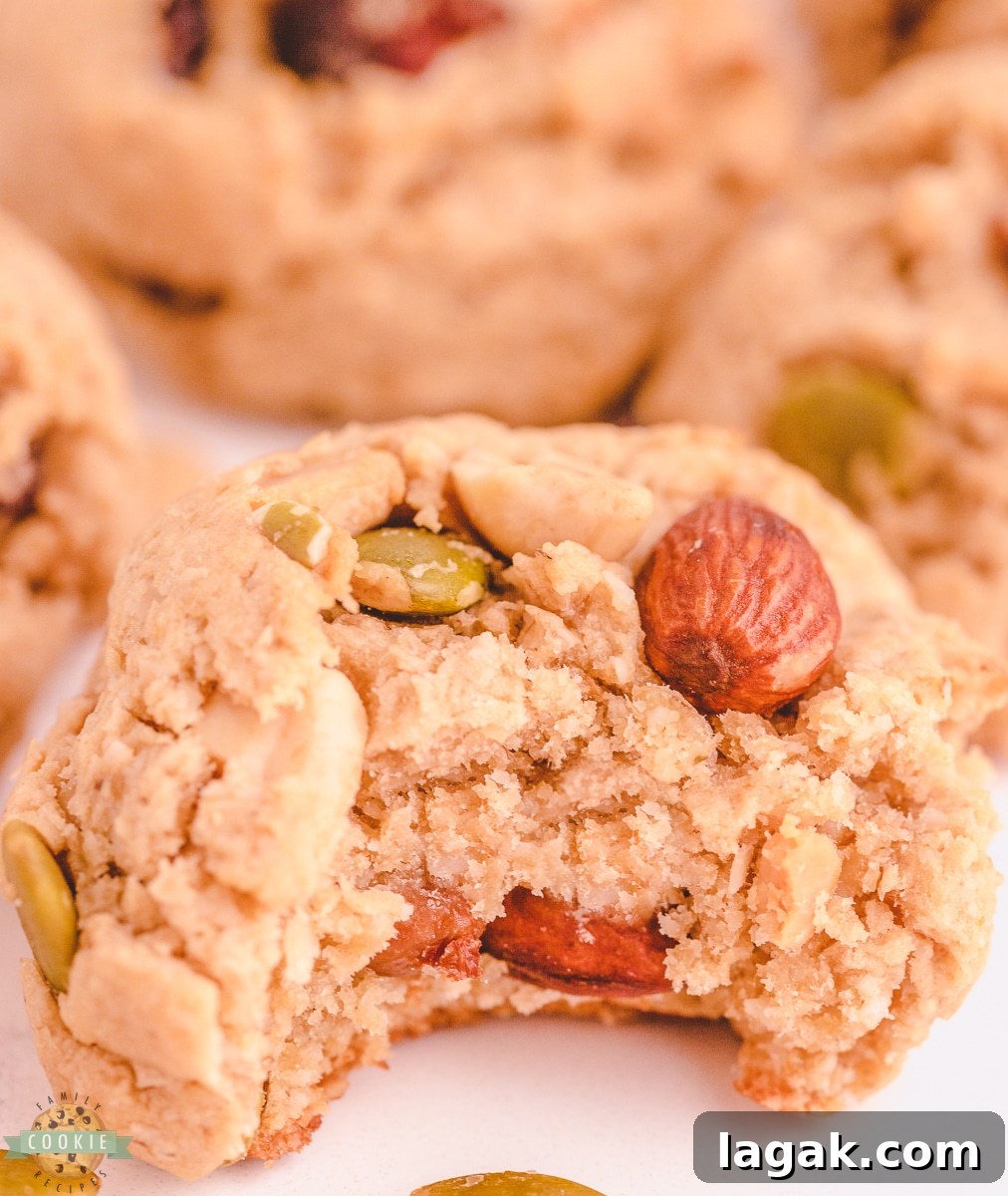 Trail Mix Peanut Butter Cookies Recipe — Chewy, Nutty Cookies 3 bite of a peanut butter cookie made with trail mix.