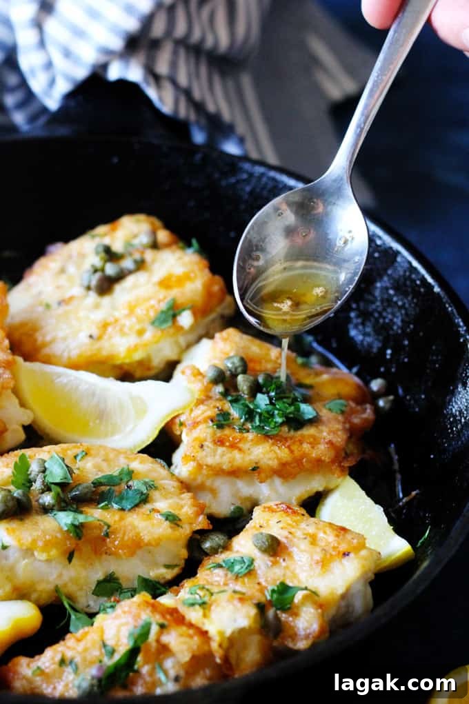 Pan Fried Cod with Meuniere Sauce - simple, quick, and delicious. Pan Fried Cod in a cast iron skillet with Meuniere Sauce spooned over