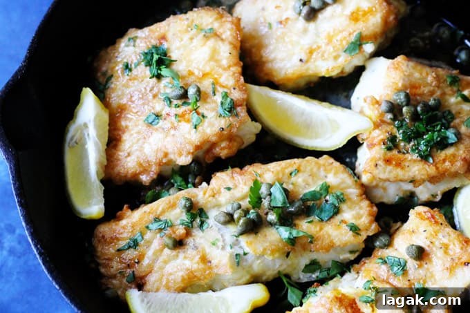 Pan Fried Cod with Meuniere Sauce Pan fried fish with butter lemon sauce in a skillet