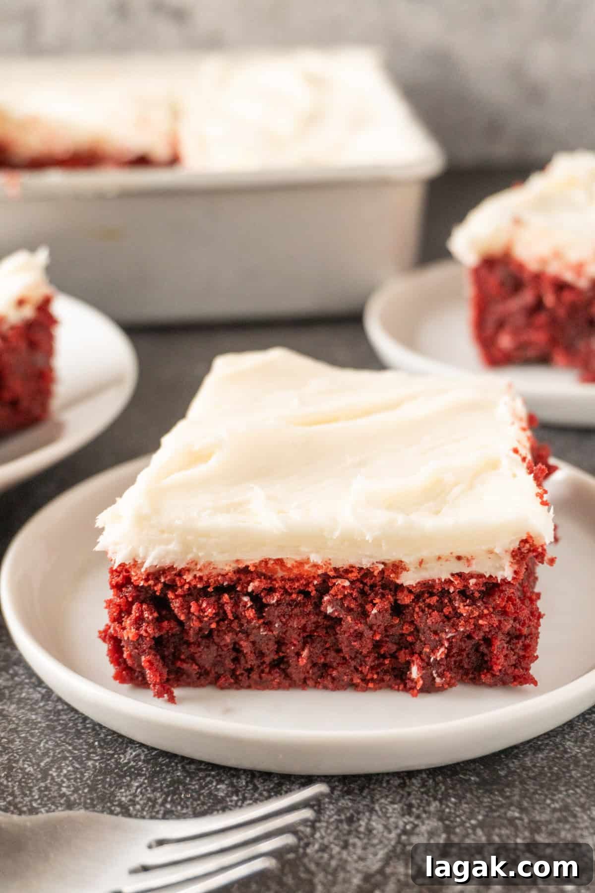Red Velvet Brownies Recipe with Cream Cheese Swirl 2 red velvet brownie with cream cheese frosting on white plate.