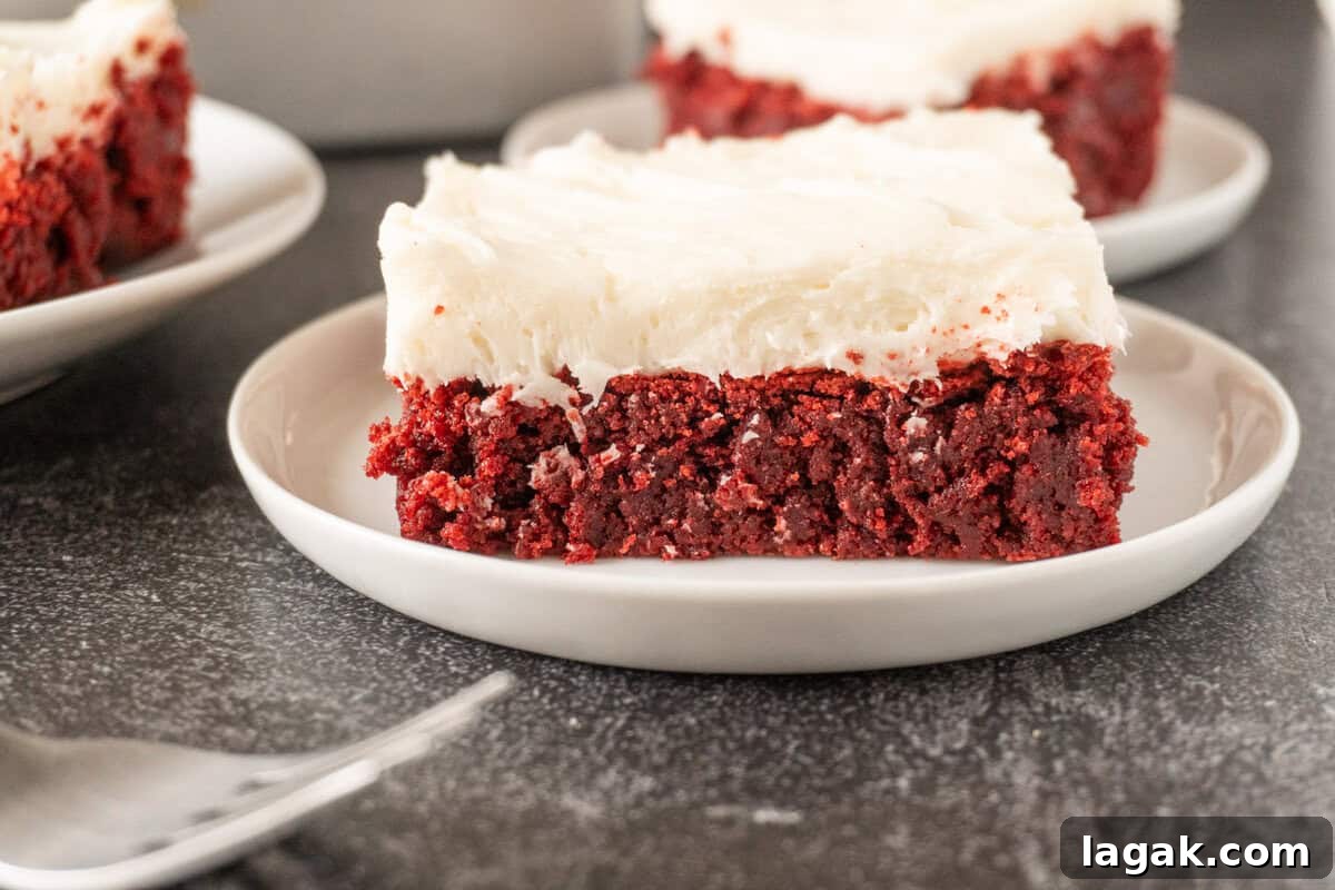Red Velvet Brownies Recipe with Cream Cheese Swirl 12 red velvet brownie with cream cheese frosting on white plate.