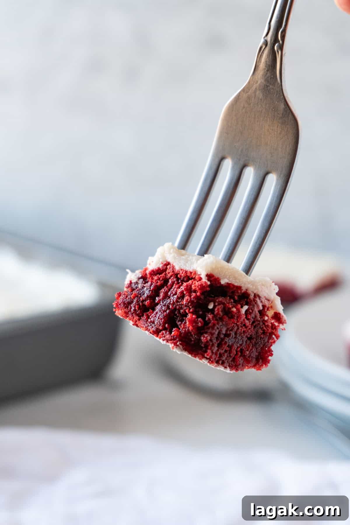 Red Velvet Brownies Recipe with Cream Cheese Swirl 3 piece of red velvet brownie with cream cheese frosting on end of fork.