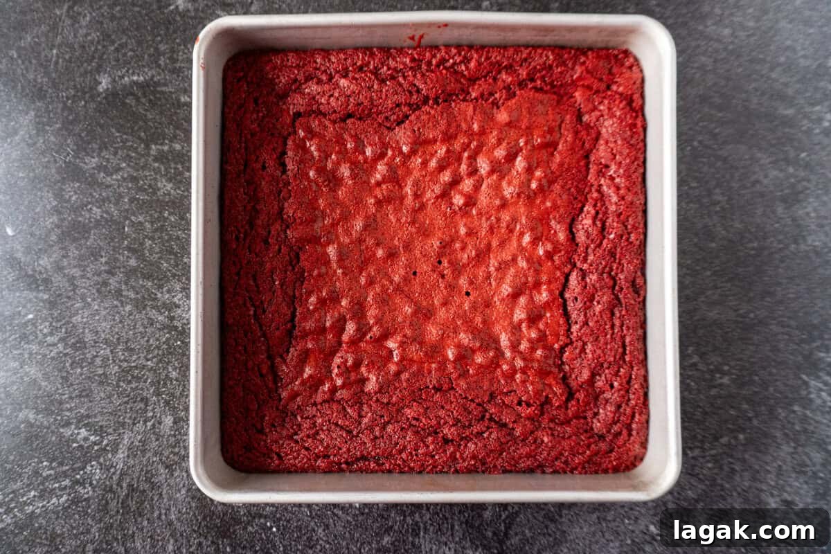 Red Velvet Brownies Recipe with Cream Cheese Swirl 5 red velvet brownie baked in a square pan.