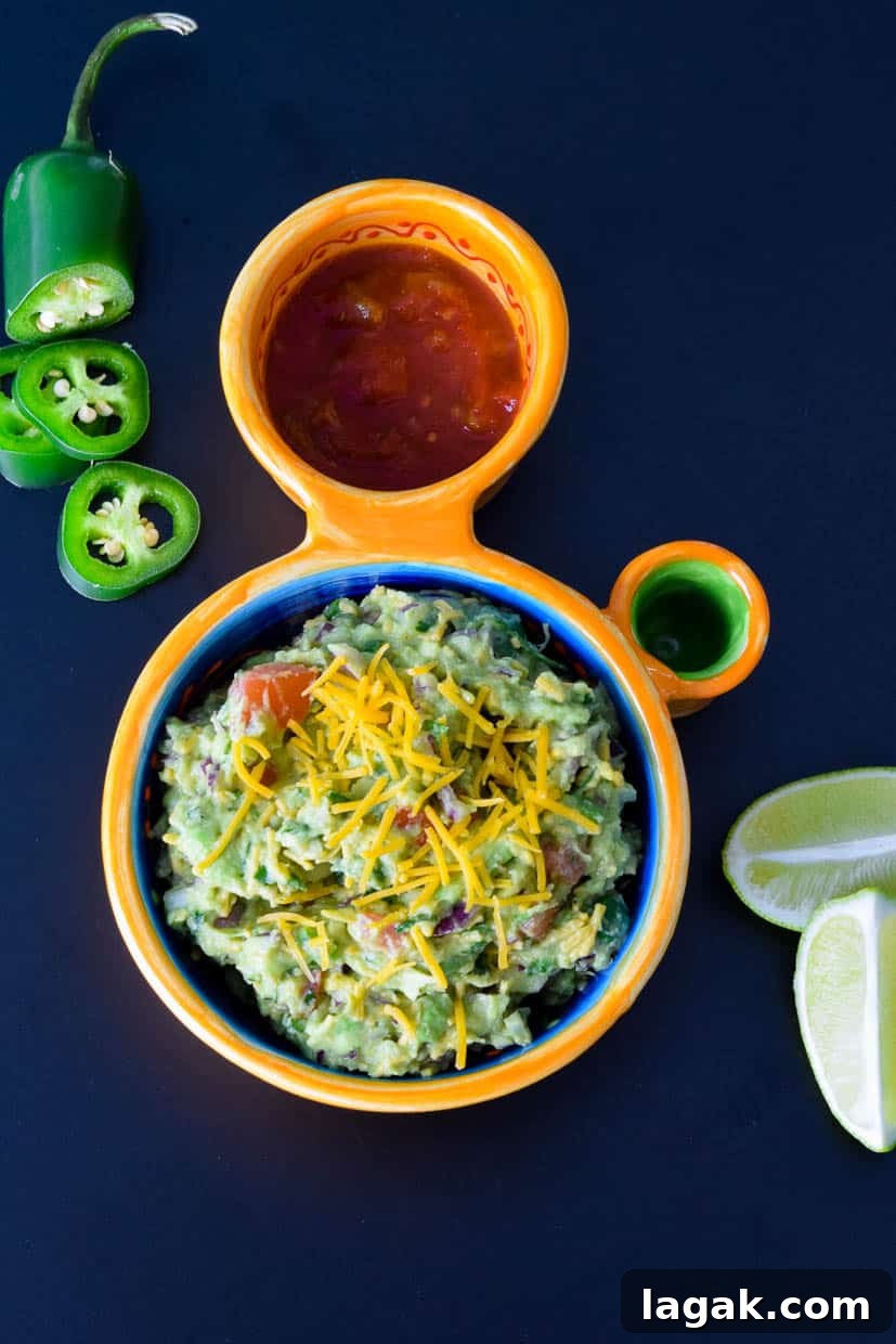 Cheesy Guacamole Recipe: Creamy Mexican Dip with Melted Cheese 4 Cheesy Guacamole in Mexican dish with sliced jalapeño