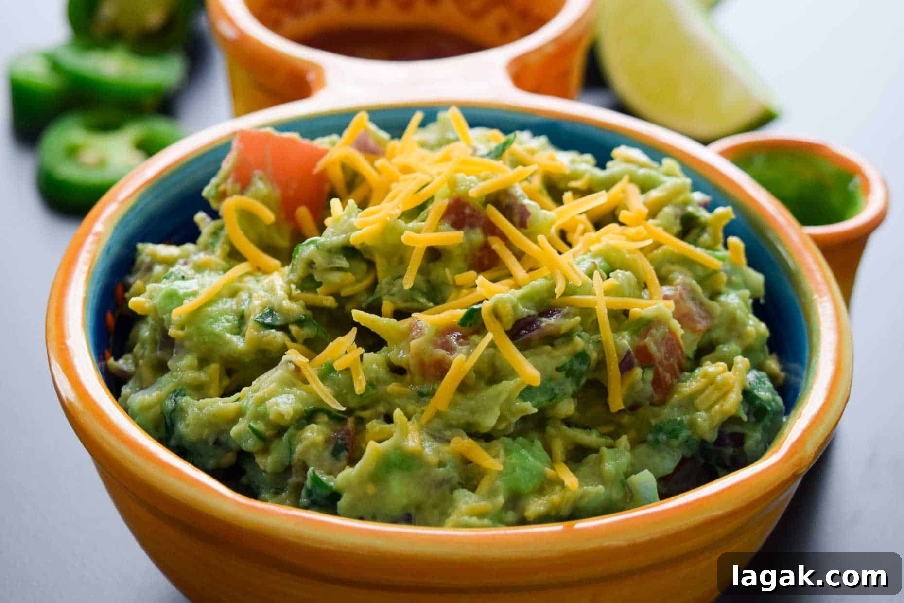 Cheesy Guacamole Recipe: Creamy Mexican Dip with Melted Cheese 3 Cheesy Guacamole served in Mexican dish side view