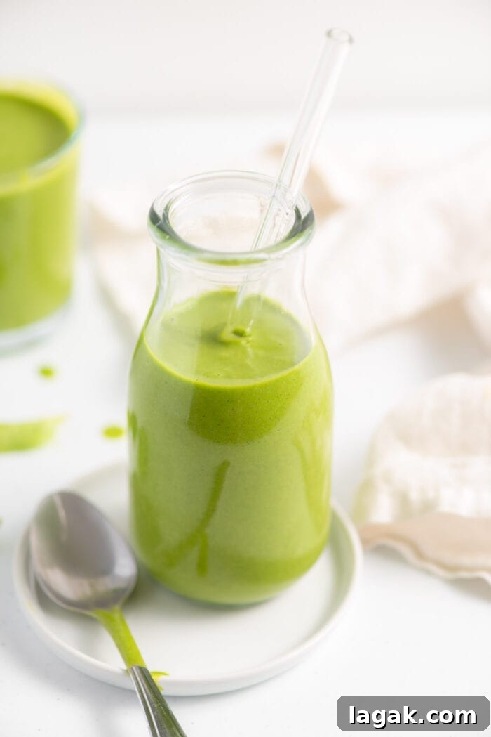 Top Vegetables to Add to Your Smoothies for Flavor & Nutrition 8 Green smoothie in a jar with another smoothie in the background.