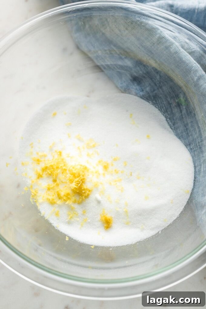 Lemon Olive Oil Zucchini Muffins with Light Citrus Glaze 3 Sugar and lemon zest in a prep bowl.