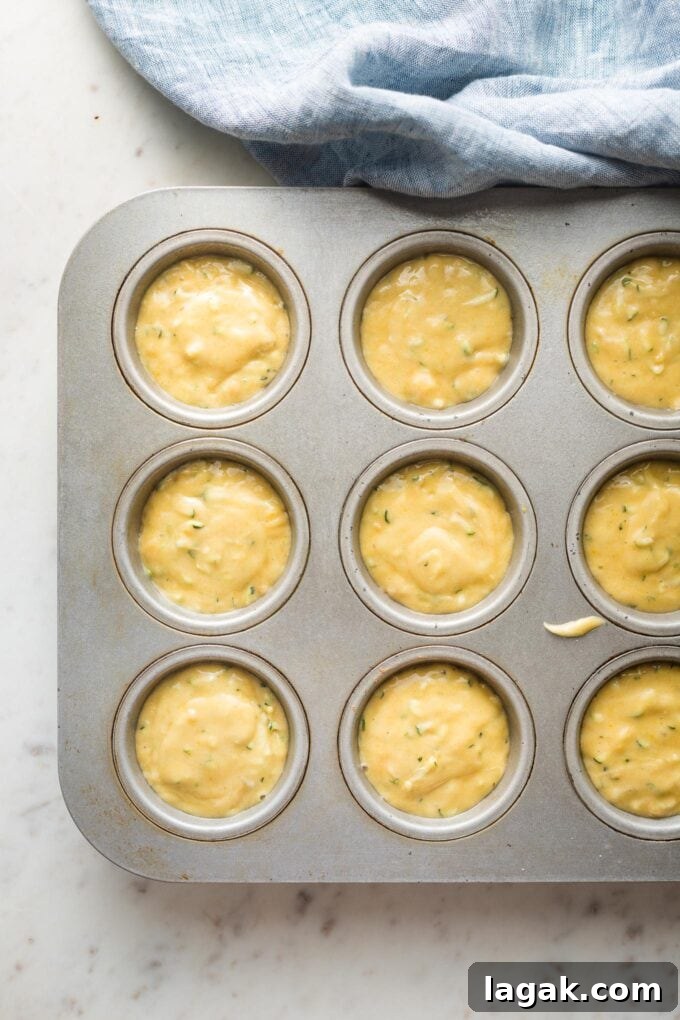 Lemon Olive Oil Zucchini Muffins with Light Citrus Glaze 7 Muffin batter divided among wells of a baking pan.