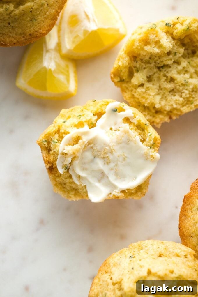 Lemon Olive Oil Zucchini Muffins with Light Citrus Glaze 10 Close-up of a lemon zucchini muffin split open and served with soft butter.