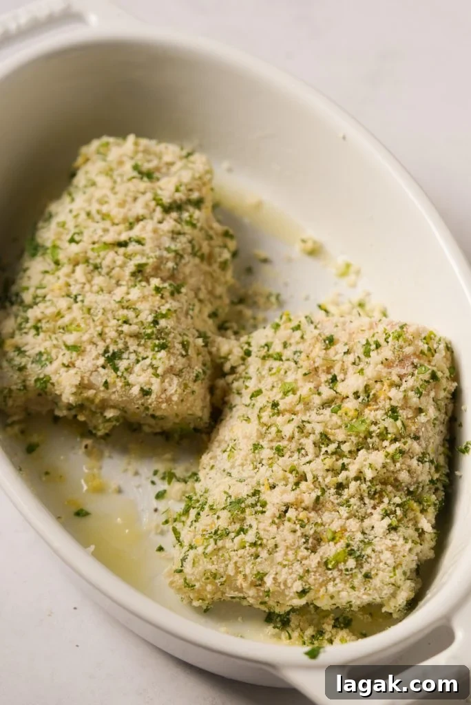cod fillets coated in a panko parmesan breadcrumb mixture before baking