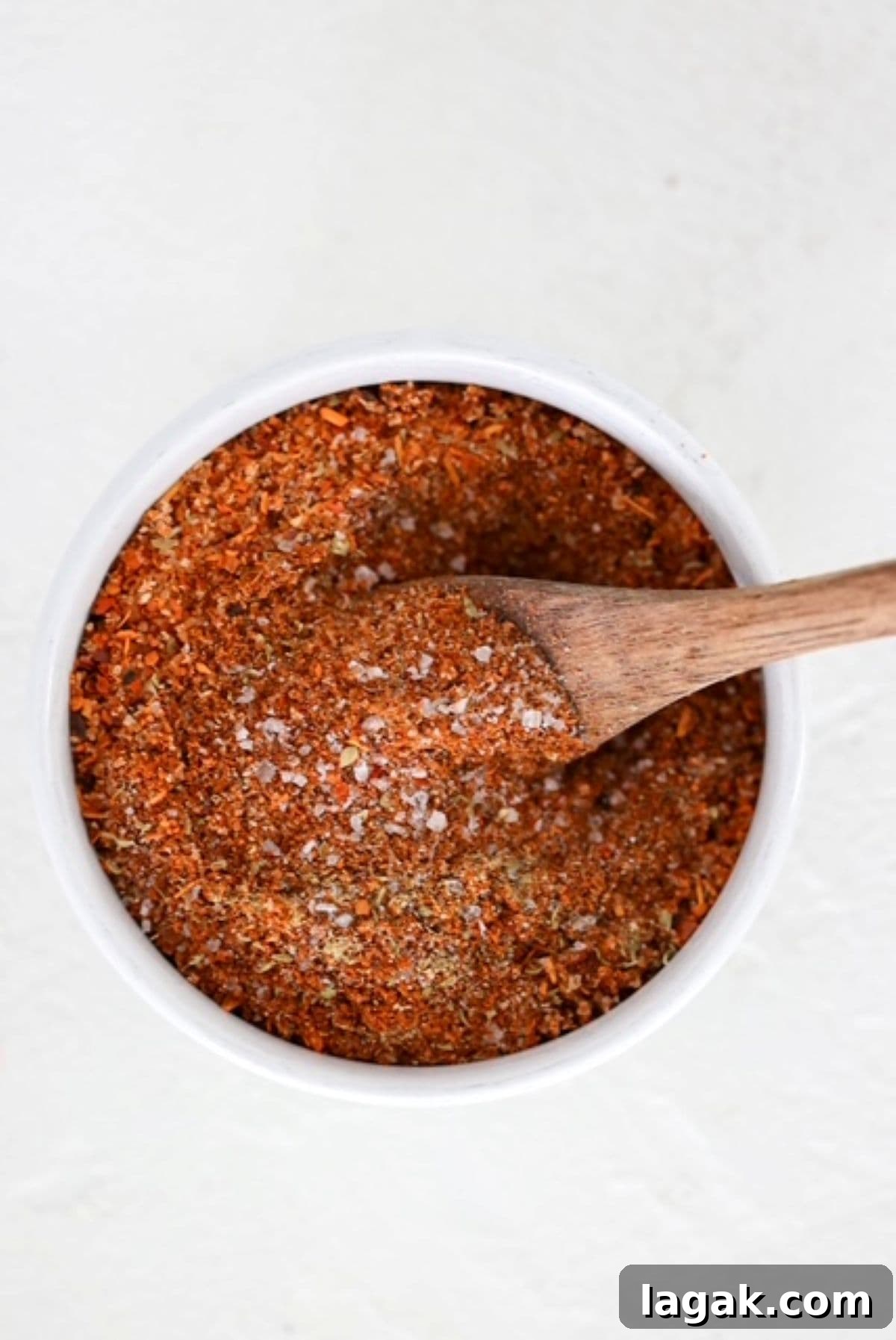 Homemade Chicken Taco Seasoning in a small white bowl with a white measuring spoon.