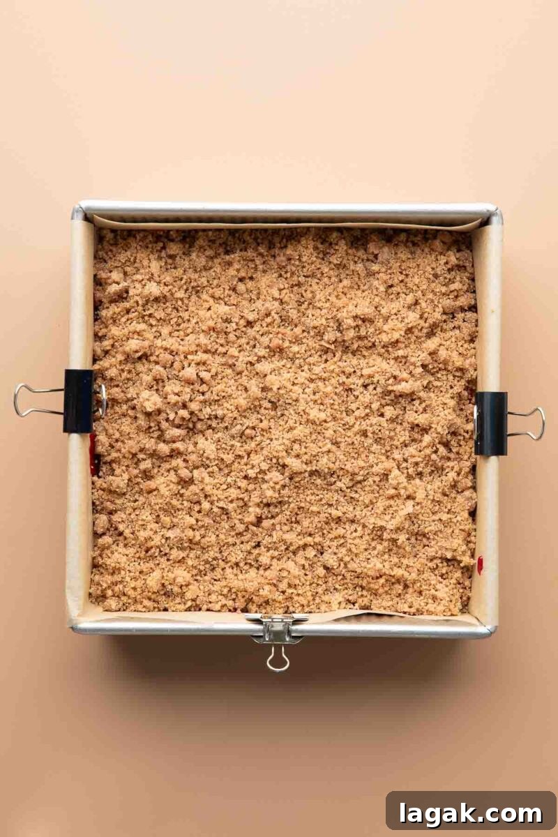 cinnamon coffee cake crumble topping added on top of cranberry sauce and pumpkin batter