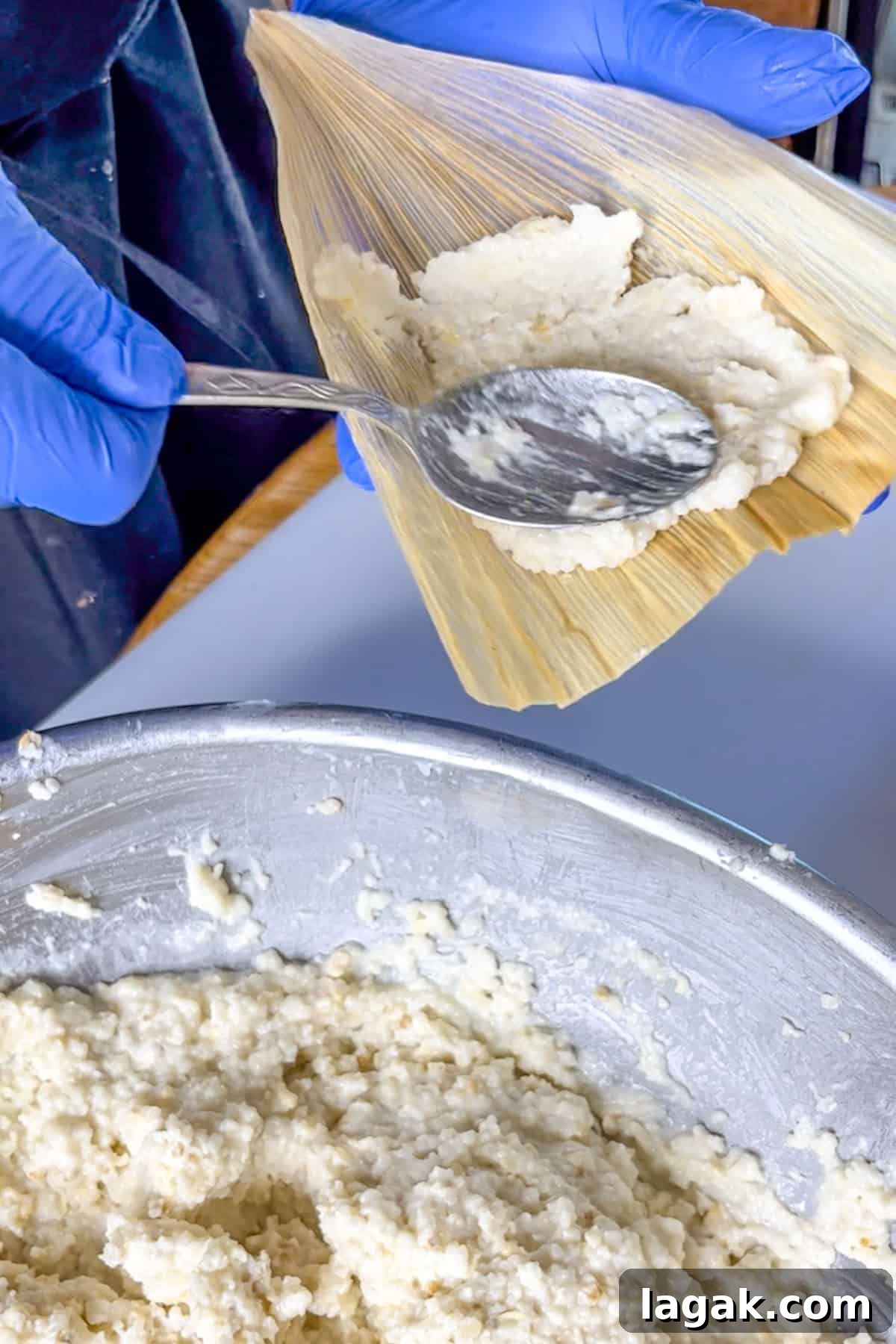 Refried Bean Tamales Recipe – Authentic Mexican Tamales 8 Spreading masa on a corn husk