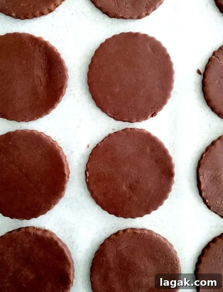 double chocolate sandwich cookies cut out and on baking sheet