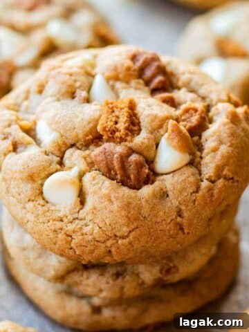 Baked white chocolate biscoff cookie stack of 3 on metal baking pan.