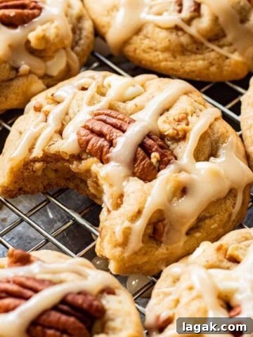 Baked Maple Cookies on metal pan with bite out of one.