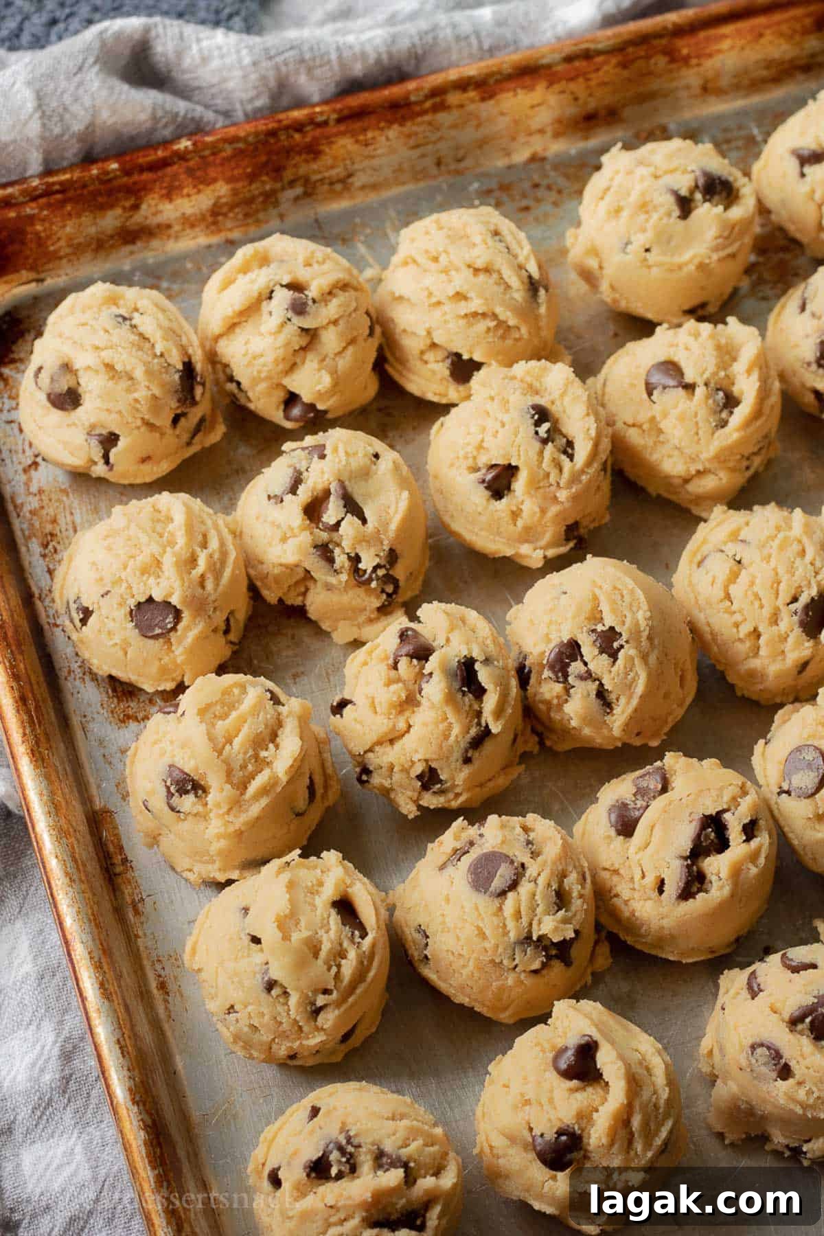 Extra-Soft Vanilla Pudding Chocolate Chip Cookies 8 Raw cookie dough balls on baking sheet.