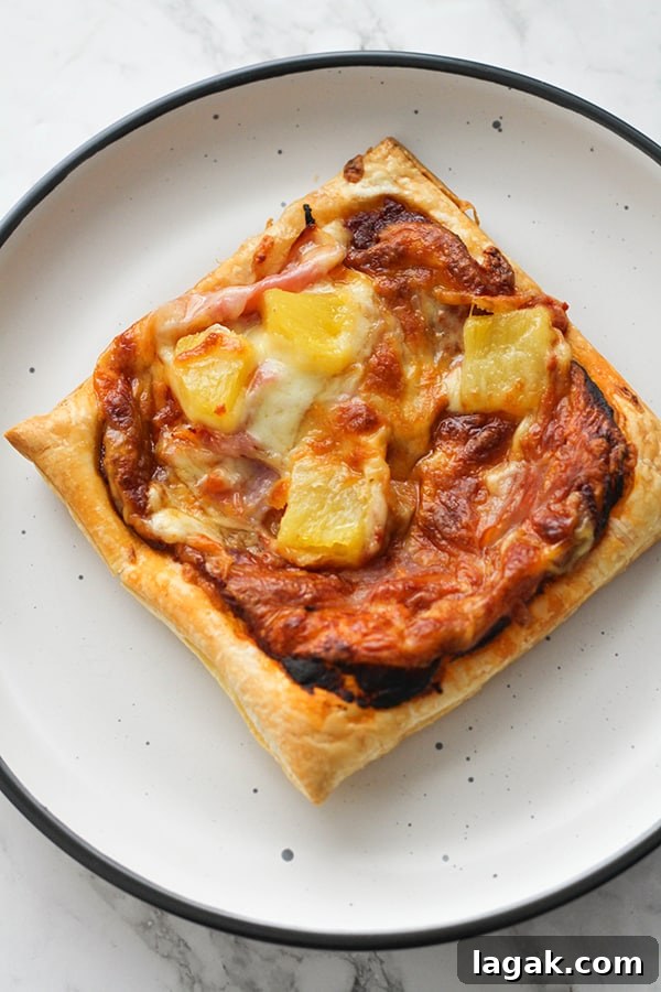 Crispy Puff Pastry Pizza Recipe — Quick Homemade Pizzas 5 pizza on a white plate.