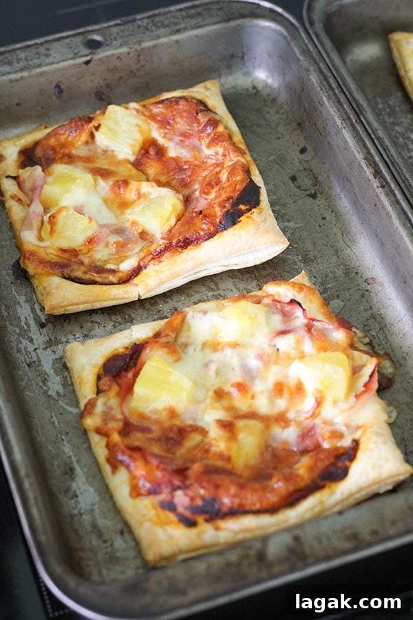 Crispy Puff Pastry Pizza Recipe — Quick Homemade Pizzas 6 puff pastry pizzas on a baking tray.