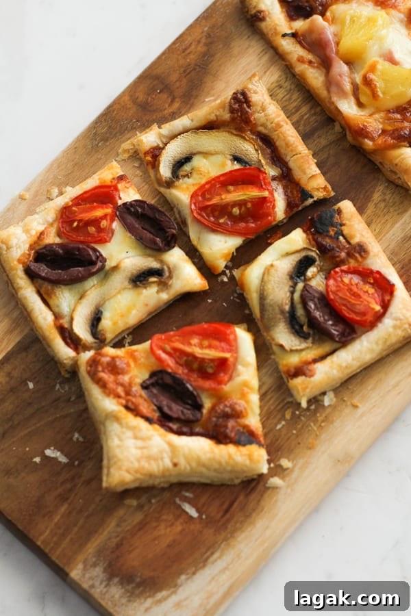 Crispy Puff Pastry Pizza Recipe — Quick Homemade Pizzas 7 slices of pizza on a wooden serving board.