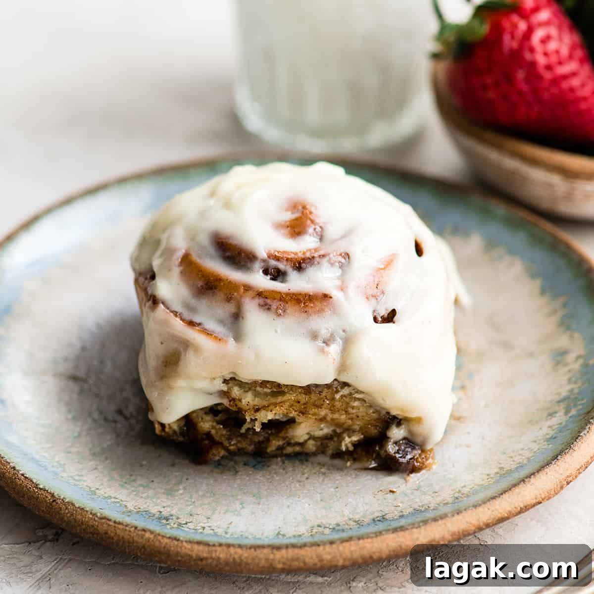 Serve Cinnamon Rolls front view of a cinnamon roll on a plate