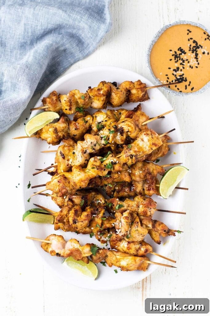 Thai Chicken Satay Recipe: Grilled Skewers with Peanut Sauce 6 A platter with lots of grilled chicken satay skewers.