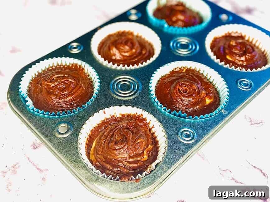 Decadent Chocolate Peanut Butter Cupcakes Recipe 7 Cupcake batter poured into lined cupcake pan.