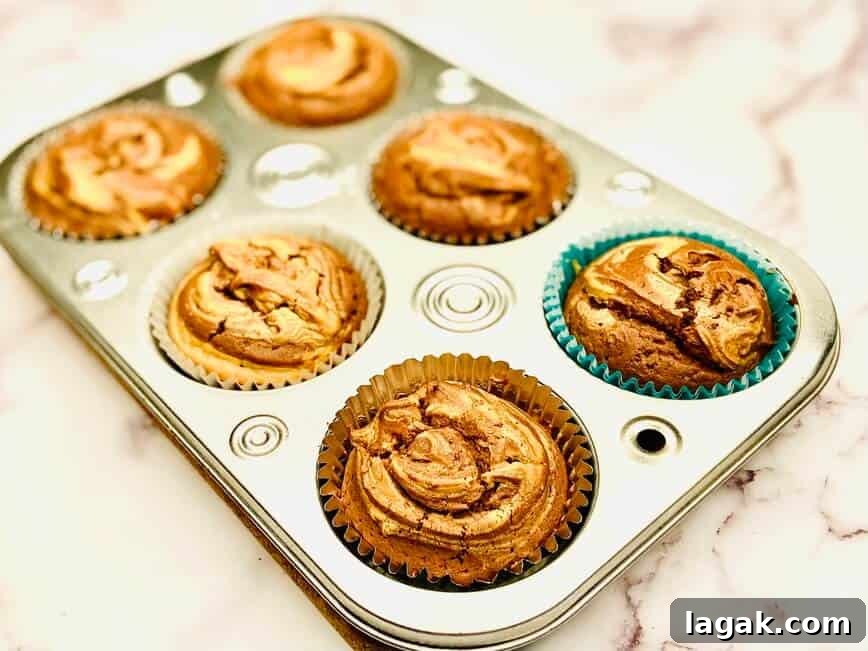 Decadent Chocolate Peanut Butter Cupcakes Recipe 8 Baked cupcakes in pan.