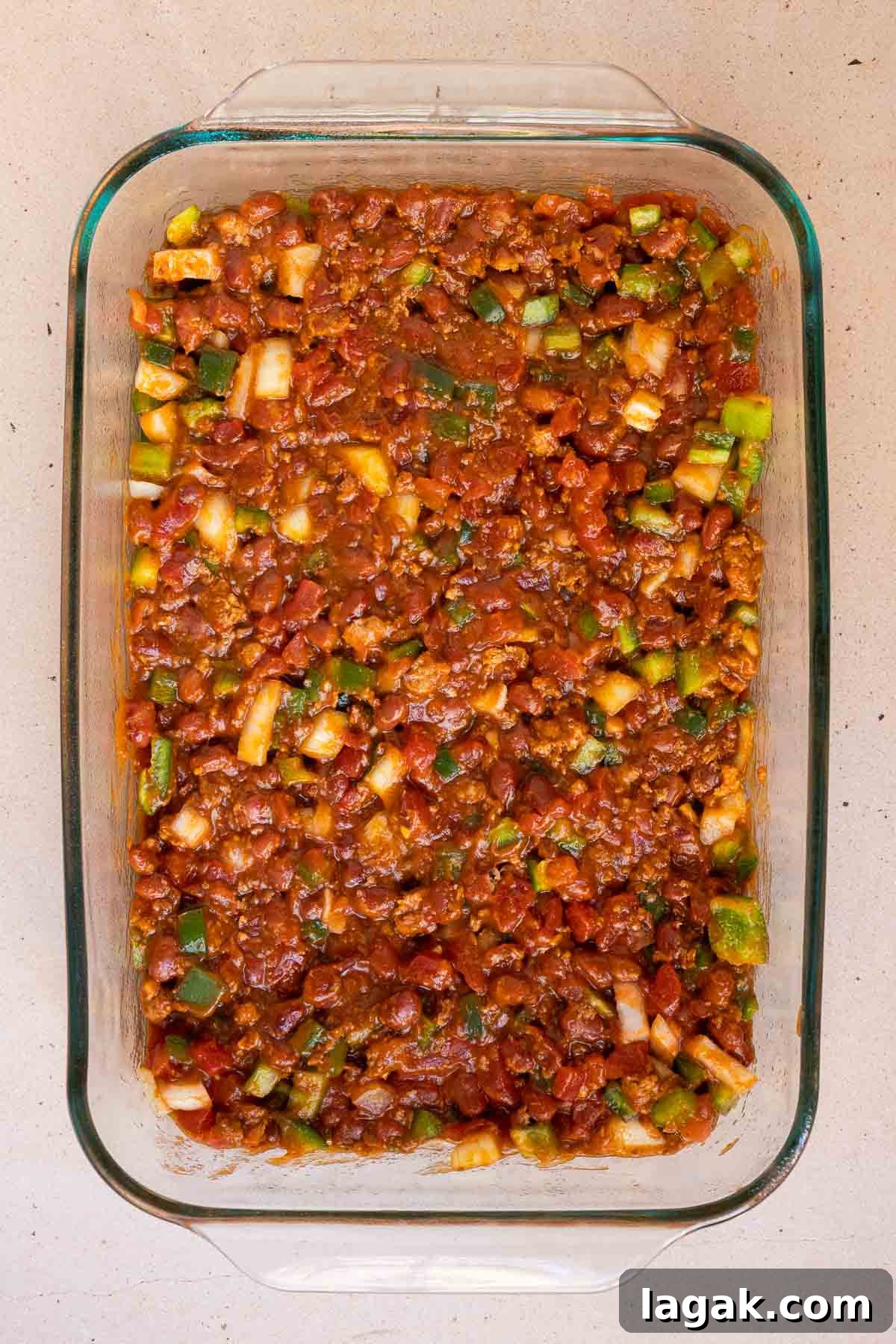 The canned chili and diced veggies are mixed together.