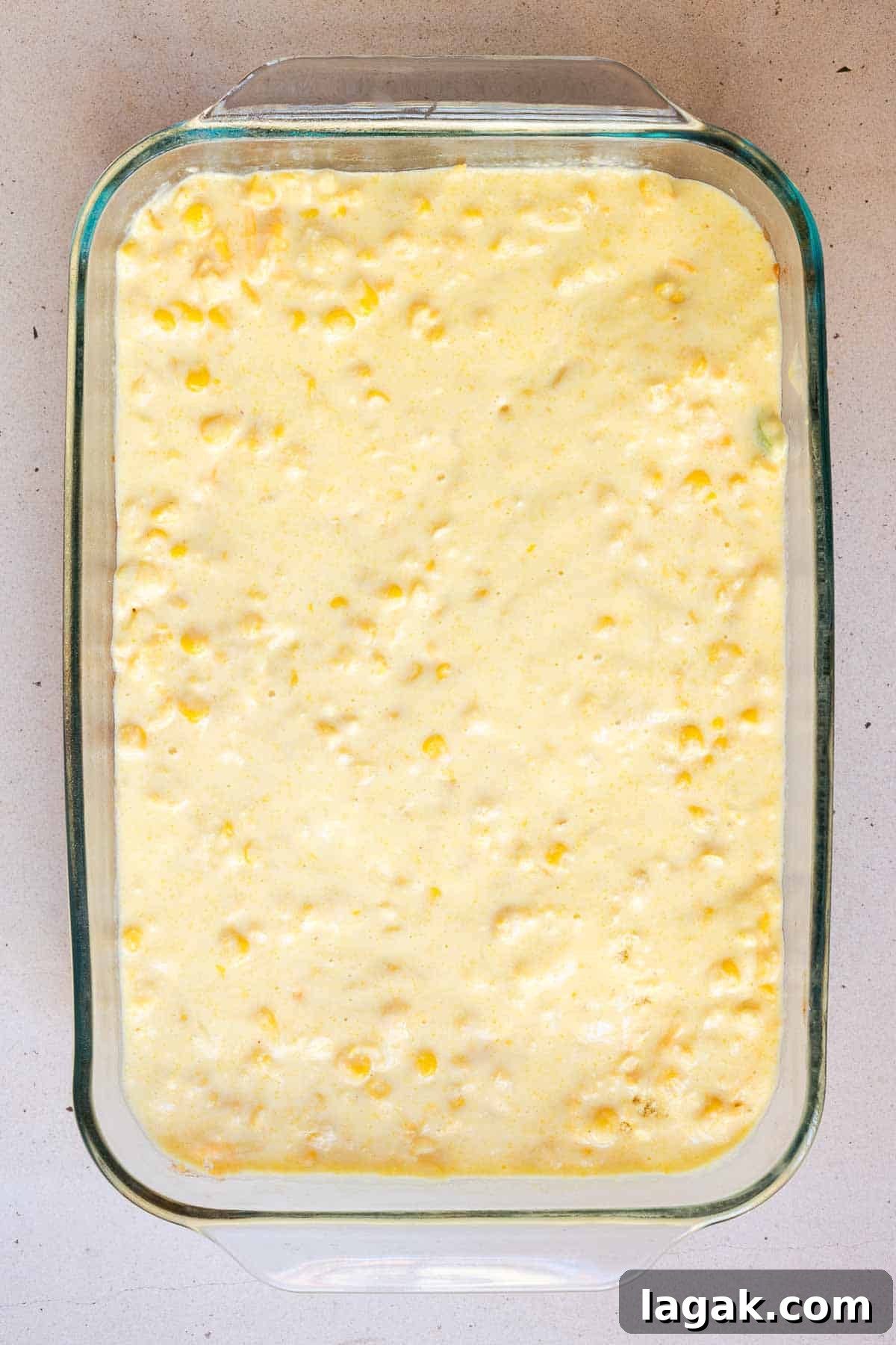 The cornbread mixture is pour in an even layer over top of the chili.