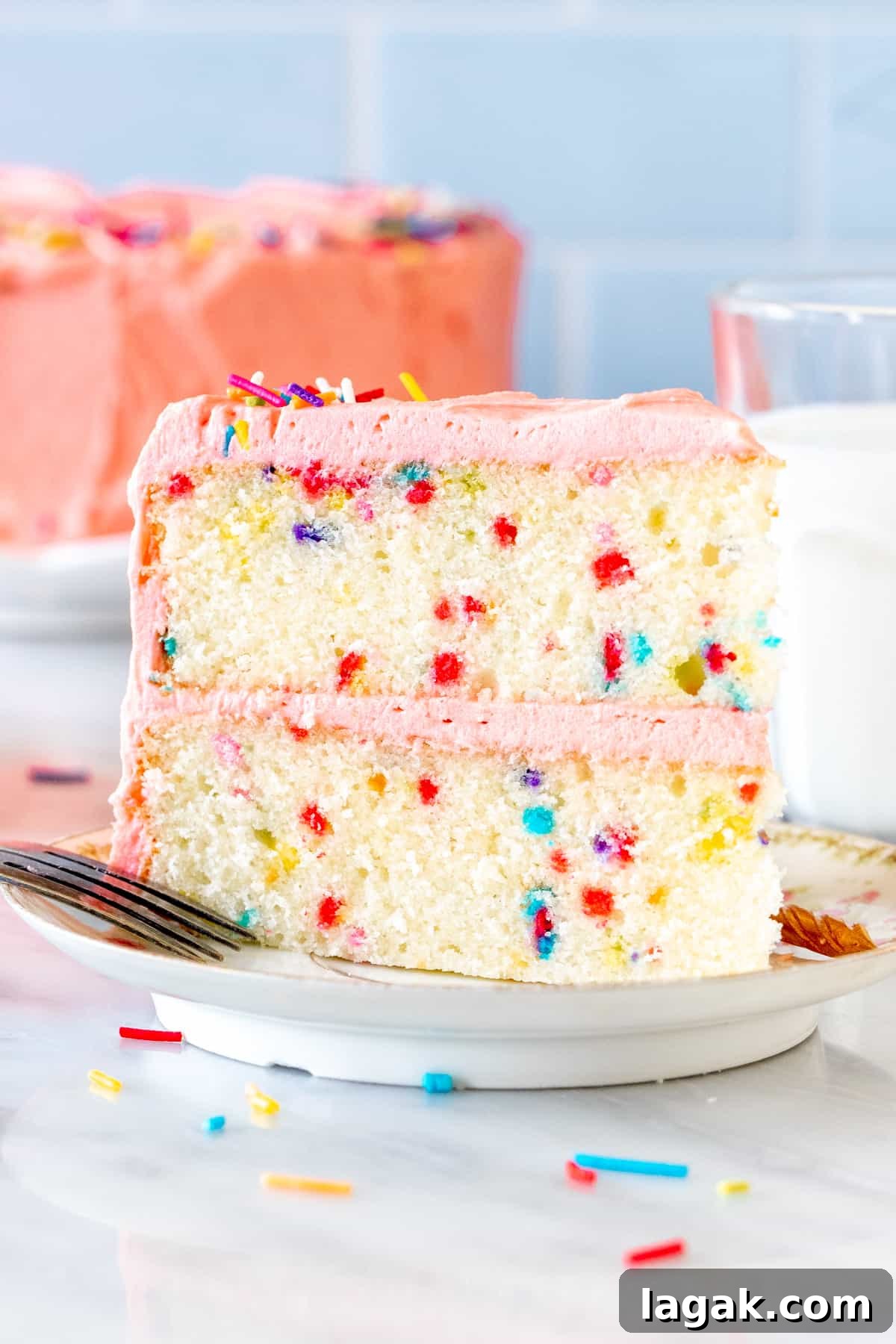 Funfetti Cake from Scratch Filled with Sprinkles 2 Slice of funfetti cake with pink frosting
