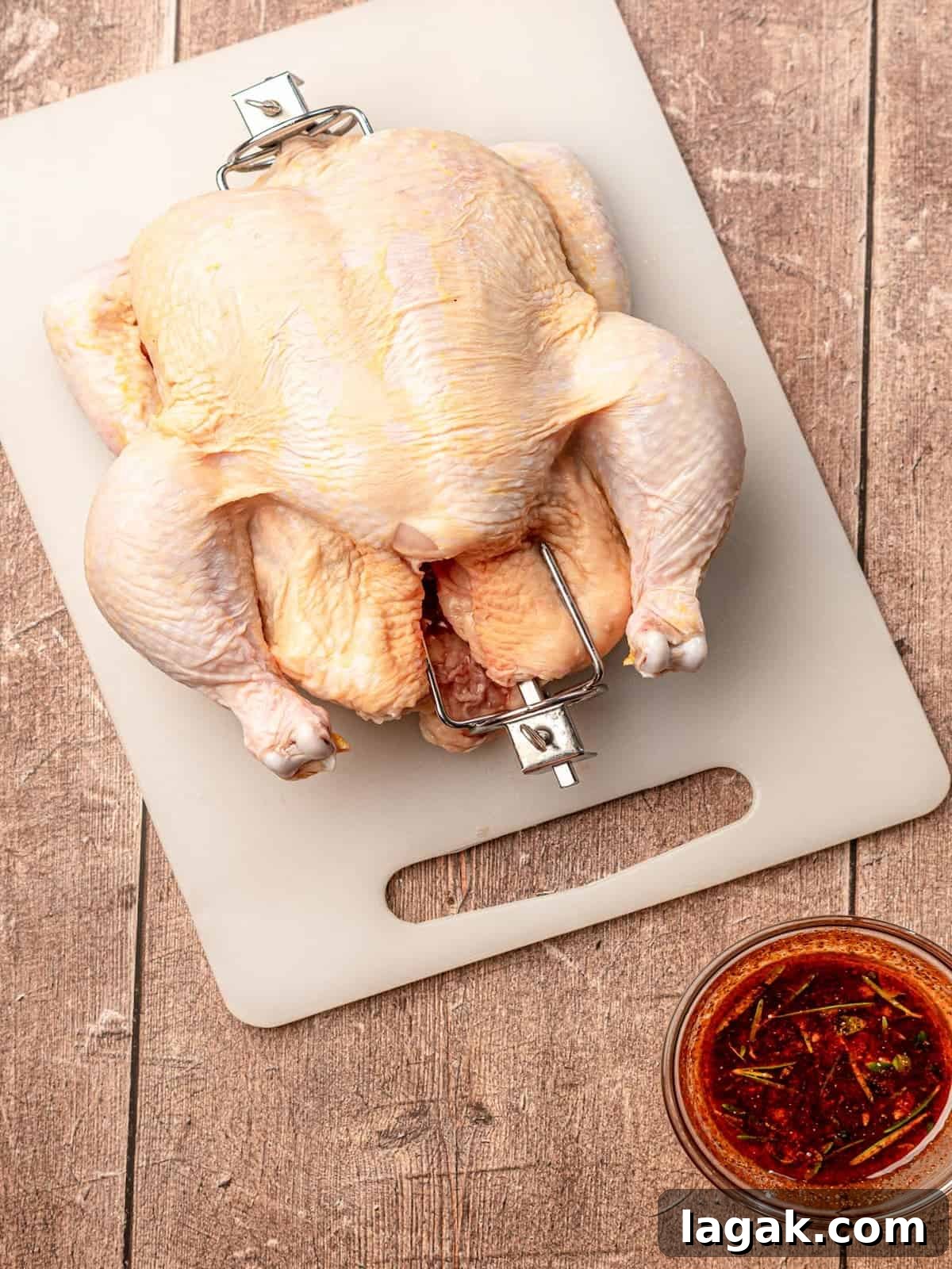 A chicken with rotisserie skewer.