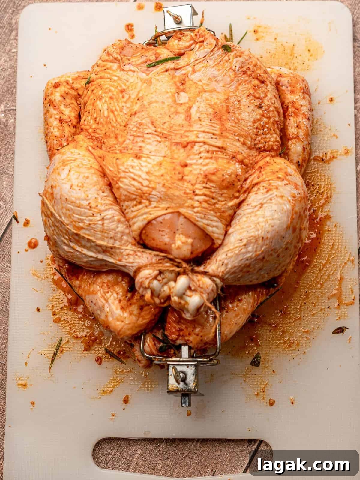 A seasoned whole chicken before cooking.