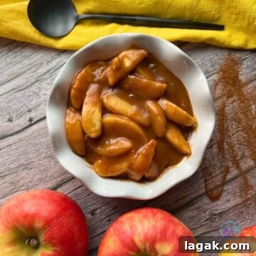 Top Apple and Pumpkin Desserts: 15 Fall Recipes to Try 15 A bowl of caramel apples with fresh apples and a spoon.