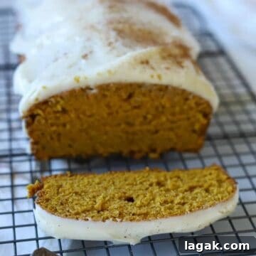 Top Apple and Pumpkin Desserts: 15 Fall Recipes to Try 16 A loaf of pumpkin bread with cream cheese frosting, sliced.