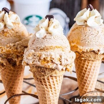 Top Apple and Pumpkin Desserts: 15 Fall Recipes to Try 6 Ice cream cones on a supportive stand, filled with ice cream and topped with whipped cream.