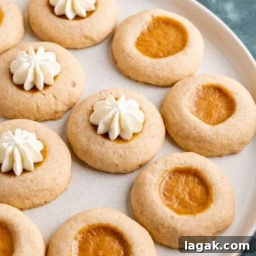Top Apple and Pumpkin Desserts: 15 Fall Recipes to Try 9 Cookies on a plate with pumpkin pie filling and cream on top.